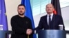 German Chancellor Olaf Scholz (right) and Ukrainian President Volodymyr Zelenskiy shake hands at a press conference in Berlin in February.