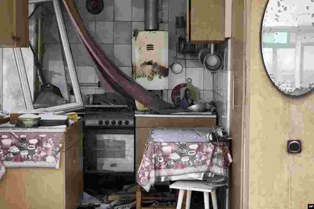 This drone image captures the exposed remains of a kitchen in a destroyed apartment building.