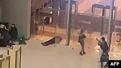 In this image grab taken from video footage, armed gunmen move past bodies of victims toward the doors of the Crocus City Hall in Krasnogorsk, outside Moscow, on March 22. At least 140 people were killed in the attack. 