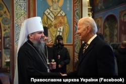 U.S. President Joe Biden speaks to Metropolitan Epifaniy, head of the Orthodox Church of Ukraine (OCU), at St. Michael's Golden-Domed Monastery in Kyiv on February 20, 2023.