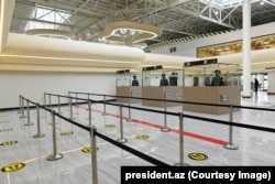 Border officers stand in their booths during the opening of the Fuzuli International Airport in October 2021.