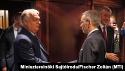 Hungarian Prime Minister Viktor Orban (left) greets Austrian Freedom Party leader Herbert Kickl during their meeting in Vienna on June 30, alongside former Czech Prime Minister Andrej Babis (in the background on the right).