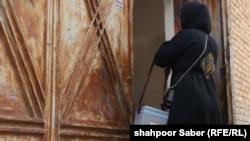 A vaccinator goes door-to-door to administer polio vaccines for young children in Afghanistan's western Herat Province in July.