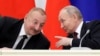 Russian President Vladimir Putin (right) speaks with Azerbaijani President Ilham Aliyev. (file photo)