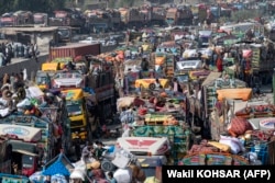 Afghan refugees arrive in trucks from Pakistan at the Torkham border crossing in Nangarhar Province on October 30, 2023.