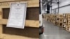 A screen grab from a viral video that purportedly shows makeshift wooden coffins with death certificates tacked onto each one at Tolmachevo Airport in the Siberian city of Novosibirsk. 