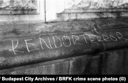 “Police terror” scrawled on a stone ledge