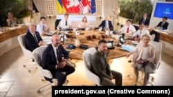 Ukrainian President Volodymyr Zelenskyy (center foreground) meets with G7 leaders at a summit in Italy earlier this year.