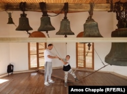 A boy is taught to ring church bells in the Lipovan village of Carcaliu, eastern Romania, on May 7.