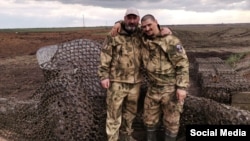 Russian soldiers pose for a photo on the line of fortifications northeast of the city of Tokmak, Zaporizhzhya region, Ukraine.