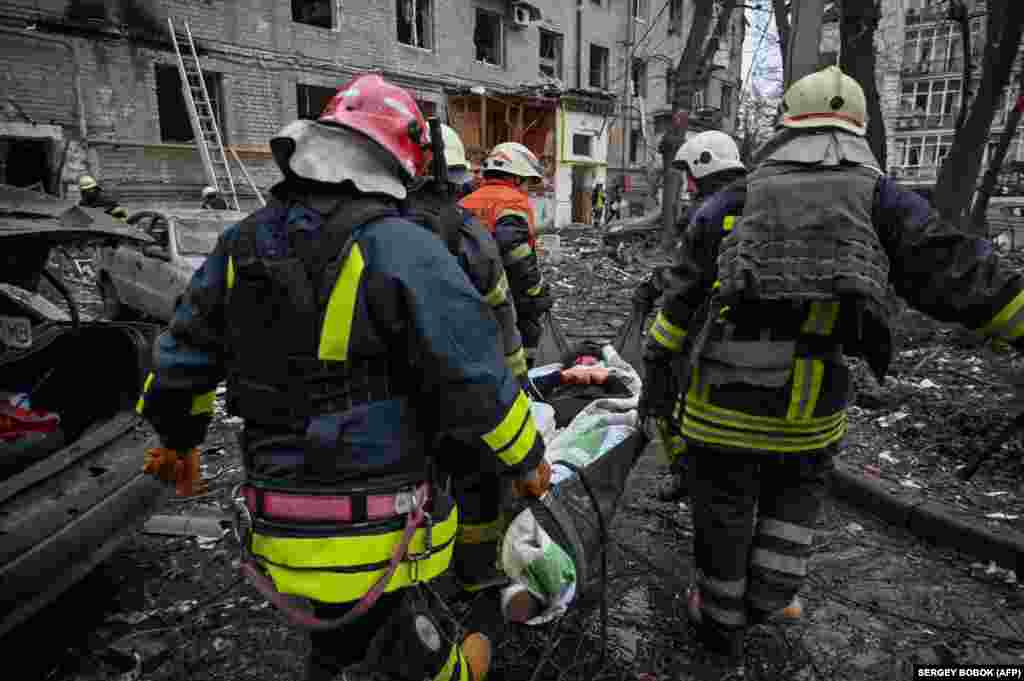 Rescuers carry a wounded woman out of a damaged residential building in Kharkiv. The Kh-47M2 Kinzhal is a hypersonic ballistic missile that is launched from the air. Russian forces rarely use such costly missiles against Ukraine due to their limited supply.