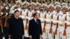 French President Emmanuel Macron (center) reviews the honor guard during a welcome ceremony with Chinese President Xi Jinping outside the Great Hall of the People in Beijing in November 2019. 