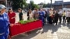 People leave flowers at a makeshift memorial for the shooting victims on June 24.