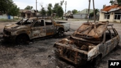 Cars destroyed by an apparent Russian cluster-munitions strike on the Ukrainian town of Lyman on July 8. 