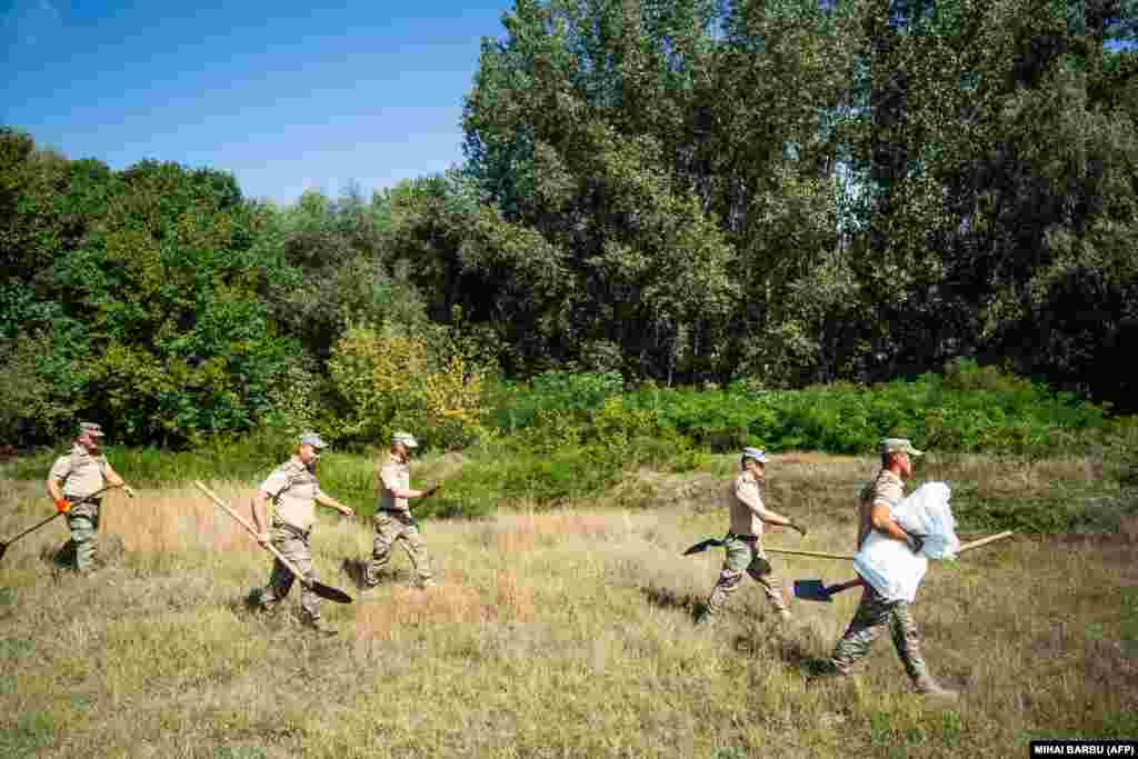 Romanian soldiers head to a field where they will begin building a bomb shelter. Bucharest made the announcement after authorities found fragments of a drone &quot;similar to those used by the Russian Army&quot; in the Plauru area across the border from Ukraine.