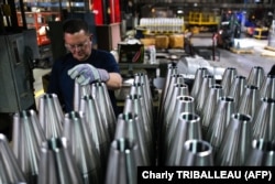 An employee handles 155 mm shells after the manufacturing process at the Scranton Army Ammunition Plant (SCAAP) in Scranton, Pennsylvania, on April 16.