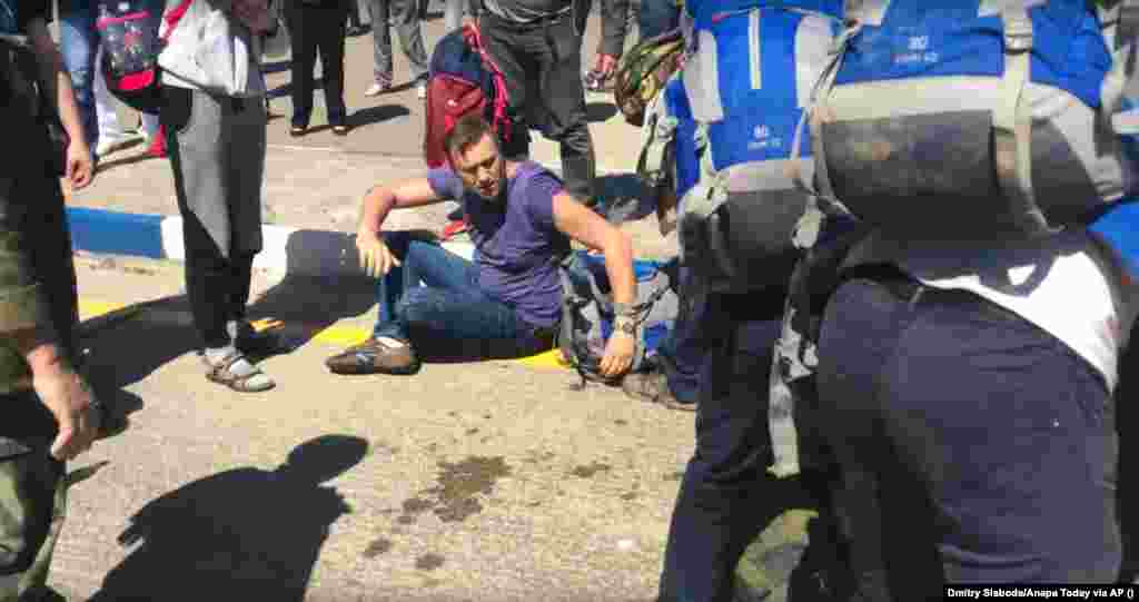 Navalny tries to get up after he and his associates were attacked by a group of Cossacks at the Anapa airport in southern Russia in May 2016. &nbsp;