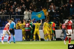 Kazakh players celebrate their historic win over Denmark in a Euro 2024 qualifying match in March 2023.