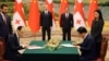 Georgian and Chinese officials ink a strategic-partnership agreement in July with Georgian Prime Minister Irakli Garibashvili (left) and his Chinese counterpart, Li Qiang, in the background.