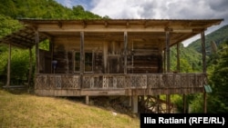 The traditional wooden homes in Gogolati feature intricately carved balconies.