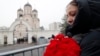 People react outside the Church of the Icon of the Mother of God ahead of the funeral of Aleksei Navalny in Moscow on March 1.