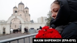 People react outside the Church of the Icon of the Mother of God ahead of the funeral of Aleksei Navalny in Moscow on March 1.