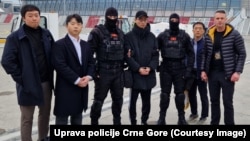 The handover of Hon Chang-joon (center) to South Korean officials at Podgorica airport on February 5.