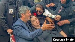 Ruhi's parents grieve at his graveside on September 6.