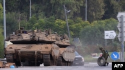 Israeli tanks are positioned near the border with Gaza in southern Israel on October 10. The White House says it has the military resources to support Israel in its war against Hamas and Ukraine. 