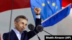 Billionaire Bidzina Ivanishvili, the de facto leader of the ruling Georgian Dream party, greets demonstrators during a Tbilisi rally in April.