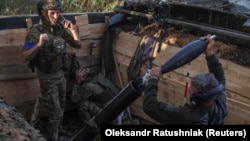 Ukrainian soldiers fire a mortar toward Russian troops at their position near a front line in the Zaporizhzhya region on September 4.
