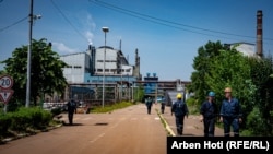 Workers outside the Ferronikeli company on June 21.