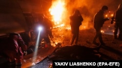 Ukrainian first responders work at the scene of an overnight drone attack in Kharkiv on April 4. Air defenses are an increasing priority for Kyiv.