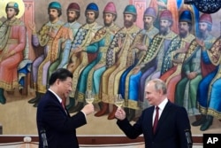 Chinese leader Xi Jinping and Russian President Vladimir Putin toast during a March summit in Moscow.