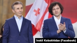 Georgian Dream founder Bidzina Ivanishvili (left) and Prime Minister Irakli Kobakhidze attend a party rally in Tbilisi in April. 