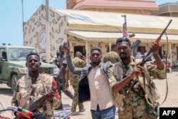 Sudanese soldiers loyal to al-Burhan pose for a picture at the Rapid Support Forces base in the Red Sea city of Port Sudan on April 16.