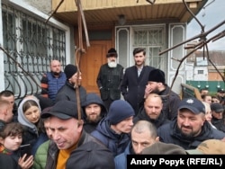 Metropolitan Antoniy watches the protest next to the Khmelnytskiy Cathedral.