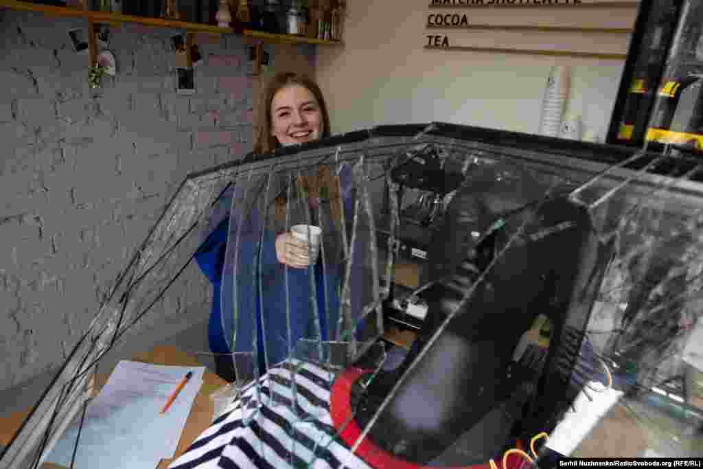 A barista at work inside her explosion-damaged cafe on March 25, 2024 after a Russian missile hit central Kyiv.&nbsp; &nbsp;