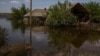 A flooded cottage in the village of Odradokamyanka that had earlier been damaged by shelling.