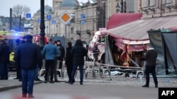 Russian investigators work at the damaged St. Petersburg cafe where Maksim Fomin (aka Vladlen Tatarsky) was killed in a blast in April.