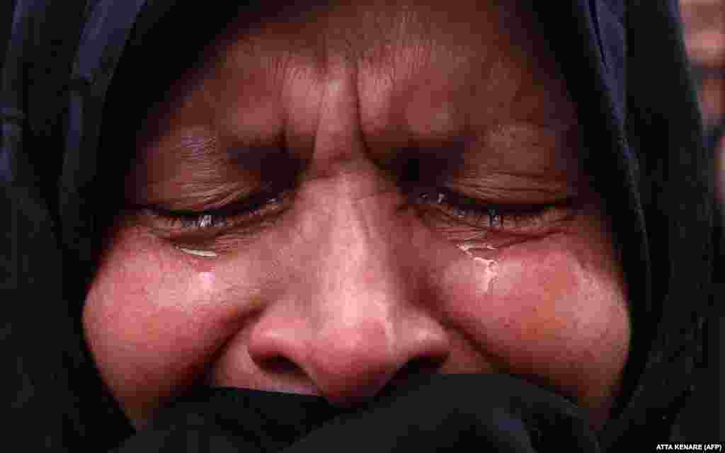 A woman mourns the death of Raisi in Tehran&#39;s&nbsp;Vali-Asr Square.