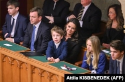 Novak sits with her husband, Istvan Veres (second left) and three children in the parliament building in Budapest on March 10, 2022.