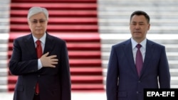 Kazakh President Qasym-Zhomart Toqaev and Kyrgyz President Sadyr Japarov stand during an official welcome ceremony prior to their meeting in Bishkek on May 26, 2022.