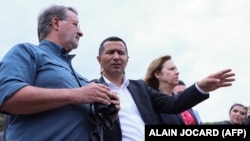 (Left to right) U.S. Senator Gary Peters (Democrat-Michigan), Syunik Governor Robert Ghukasian, and U.S. Ambassador to Armenia Kristina Kvien look out from the Armenian side of the border near the town of Kornidzor on September 23.