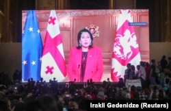 Georgian President Salome Zurabishvili addresses demonstrators via a video link during a rally to protest against the "foreign agent" bill after parliament voted to override her veto, in Tbilisi on May 28.