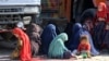 Afghan refugee women and children sit at a registration center after arriving back from Pakistan in Kandahar Province, Afghanistan, late last year. 