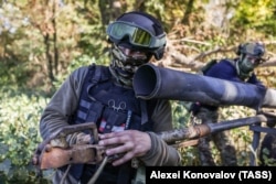 In this Russian state agency photo, soldiers of the Russian Army's Dniepr Group of Forces are seen during combat involving the use of a modified Grad multiple-rocket launcher on the left bank of the Dnieper River on October 11, 2023.