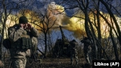 Ukrainian soldiers fire a self-propelled howitzer toward Russian positions near Bakhmut, on March 5.