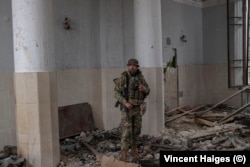 Yankee, the commander of a reconnaissance unit of the 41st Mechanized Brigade, in a destroyed railway station in Kostyntynivka.