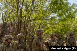 Recruits from 22nd Mechanized Brigade listen to their instructor during training.